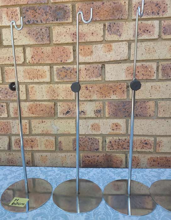 A COLLECTION OF 5 STAINLESS STEEL TABLE STANDS SOLD AS IS
