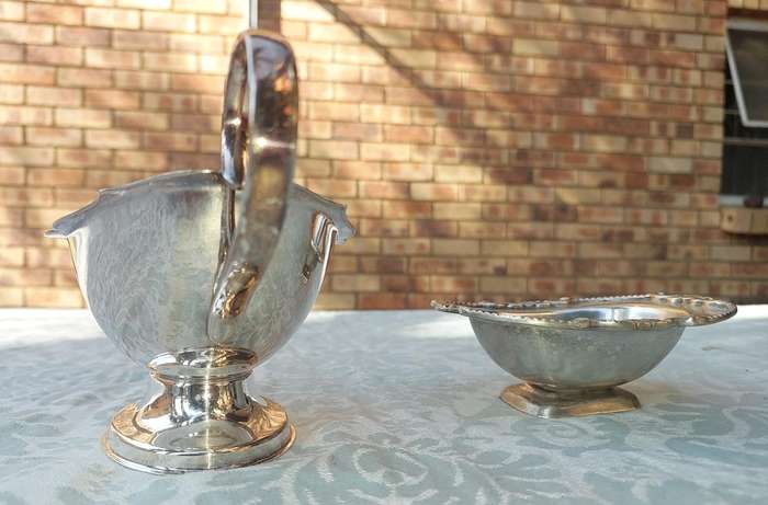 TWO VINTAGE UTENSILS A SAUCE BOAT AND A BUTTER DISH SOLD AS IS