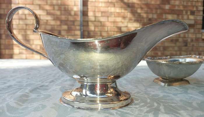 TWO VINTAGE UTENSILS A SAUCE BOAT AND A BUTTER DISH SOLD AS IS