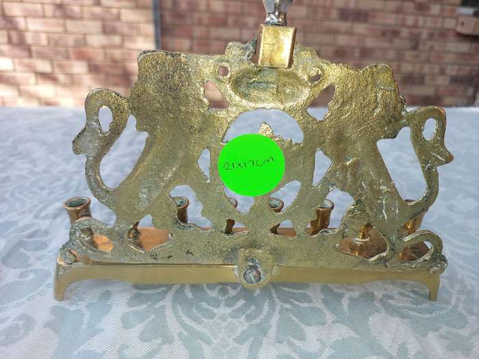 A VINTAGE BRASS CAST HANNUKKA MENORAH WITH LION CRESTS SOLD AS IS