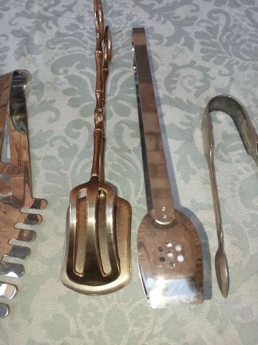 A COLLECTION OF CUTLERY TONGS SOLD AS IS