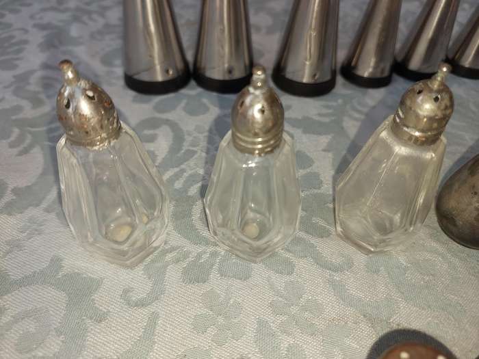 A COLLECTIONOF SALT AND PEPPER DISPENSORS SOLD AS IS