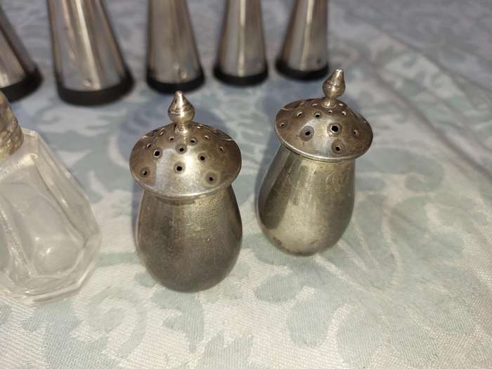 A COLLECTIONOF SALT AND PEPPER DISPENSORS SOLD AS IS