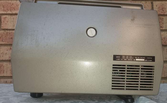 AN ANTIQUE MOVIE PROJECTOR WIYHOUT THE POWER CABLE SOLD AS IS NOT TESTED
