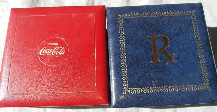 A RARE SET OF COASTERS COCA COOA AND A BLUE SET