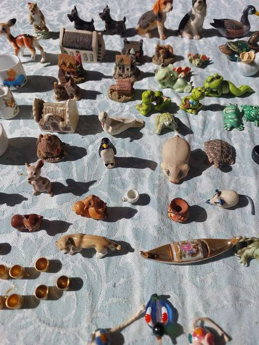 AN ENTIRE COLLECTION PORCELAIN CHARMS AND FIGURINES SOLD AS IS