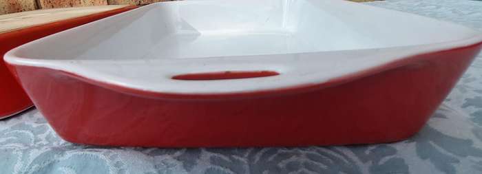 A PAIR OF RED AND WHITE CASSEROLE DISHES IN GOOD CONDITION SOLD AS IS