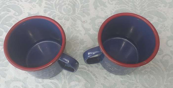 TWO ENAMEL COFFEE CUPS SOLD AS IS