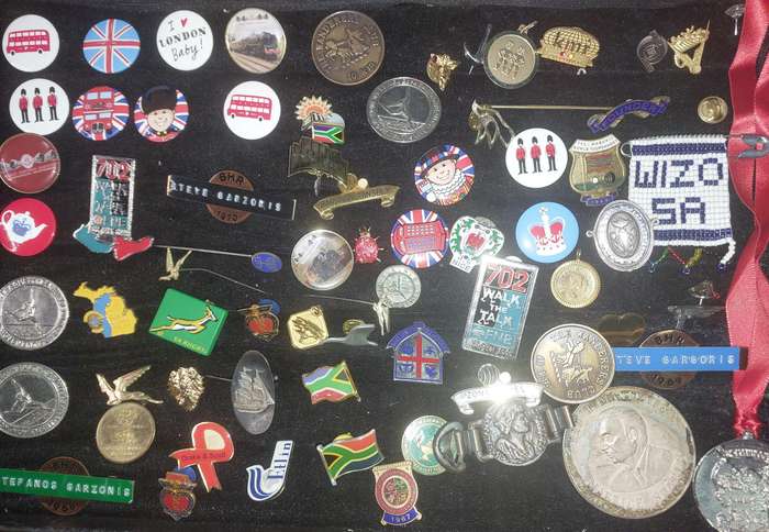 AN ENTIRE COLLECTION OF BADGES SOLD AS IS