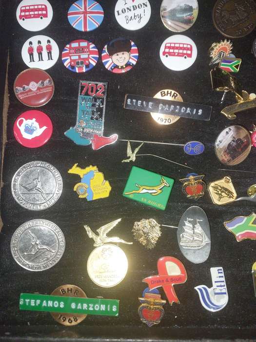AN ENTIRE COLLECTION OF BADGES SOLD AS IS