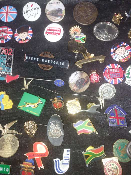AN ENTIRE COLLECTION OF BADGES SOLD AS IS