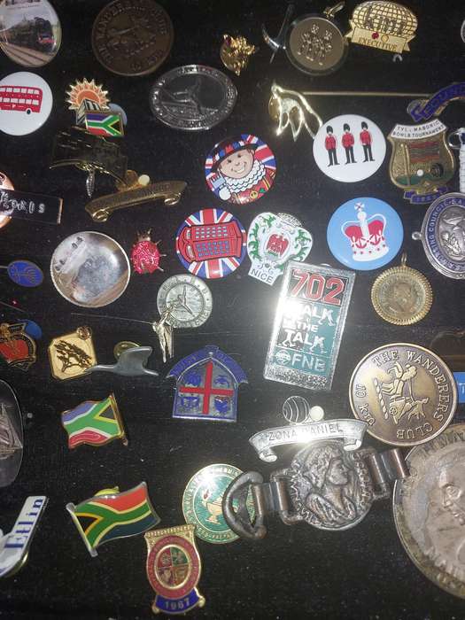 AN ENTIRE COLLECTION OF BADGES SOLD AS IS