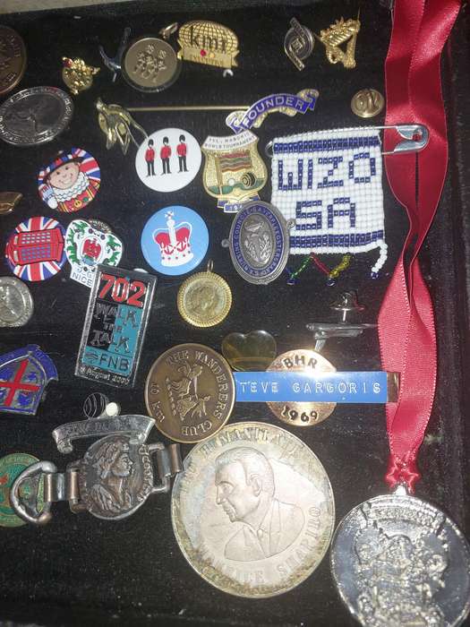 AN ENTIRE COLLECTION OF BADGES SOLD AS IS