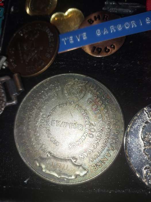 AN ENTIRE COLLECTION OF BADGES SOLD AS IS
