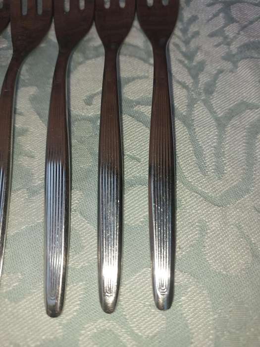 A SET OF 5 CAKE FORKS SOLD AS IS
