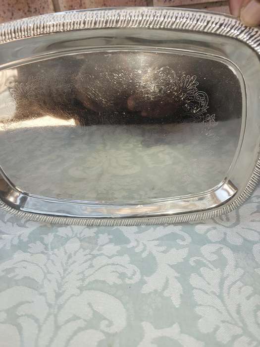A STAINLESS STEEL SERVING TRAY SOLD AS IS