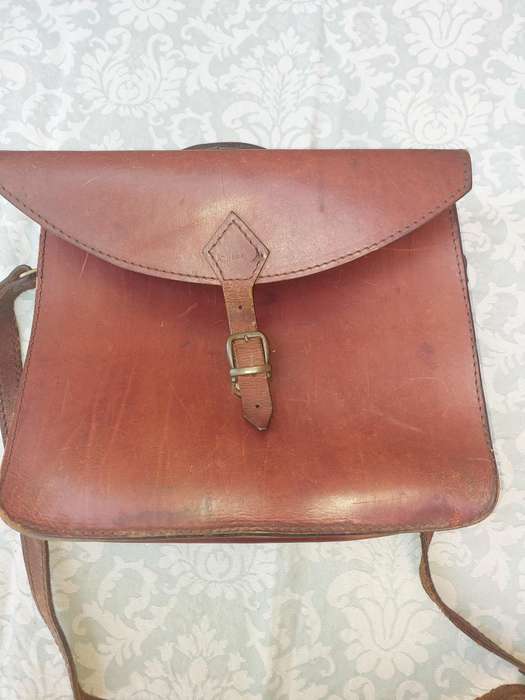 A BROWN LEATHER BRIEF CASE SOLD AS IS