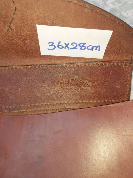 A BROWN LEATHER BRIEF CASE SOLD AS IS