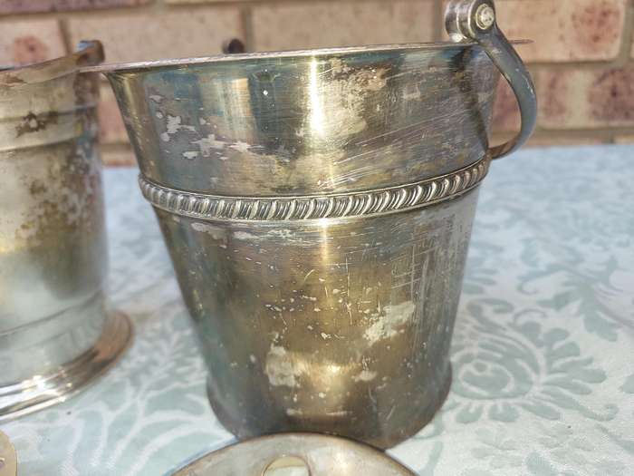 A COLLECTION OF VINTAGE SILVER PLATED ICE BUCKETS SOLD AS IS