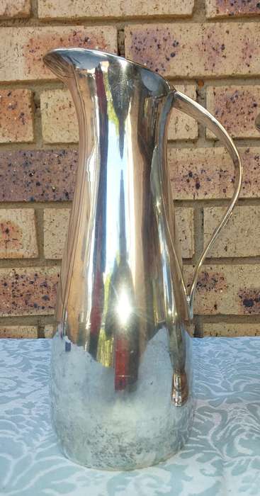 A COLLECTION OF WATER JUGS SOLD AS IS