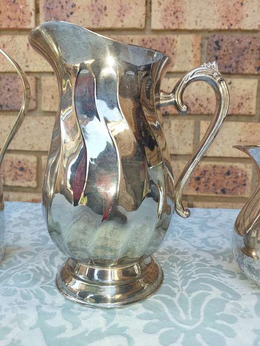 A COLLECTION OF WATER JUGS SOLD AS IS