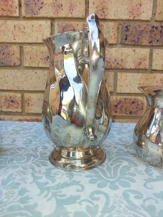 A COLLECTION OF WATER JUGS SOLD AS IS