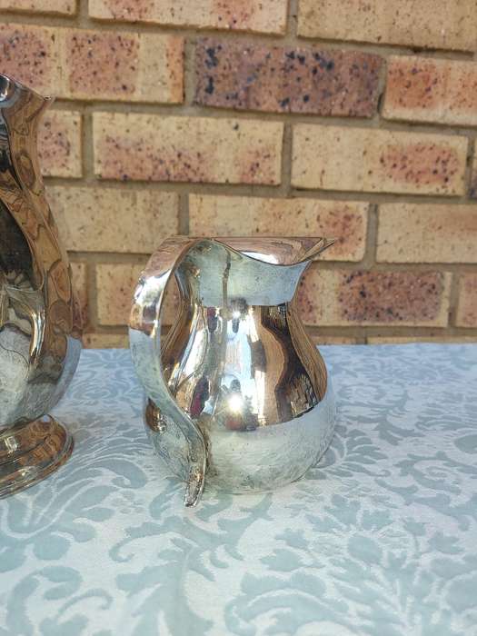 A COLLECTION OF WATER JUGS SOLD AS IS