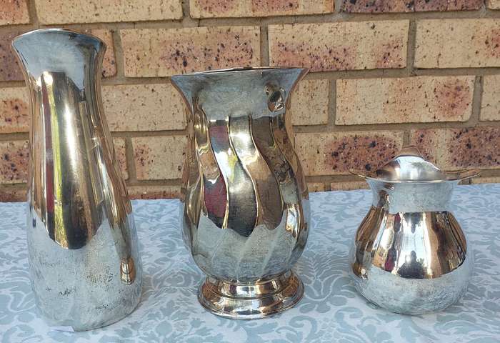 A COLLECTION OF WATER JUGS SOLD AS IS