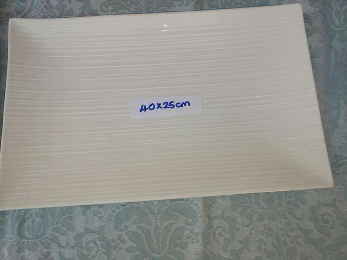 A COLLECTION OF WHITE PORCELAIN PLATTERS SOLD AS IS