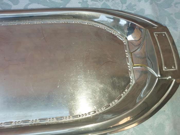 A SILVER PLATED RECTANGULAR SERVING PLATER SOLD AS IS