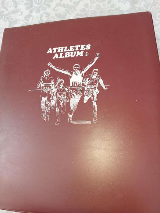 AN ENTIRE ATHLETES ALBUM WITH ALL THE MEDALS SOLD AS IS