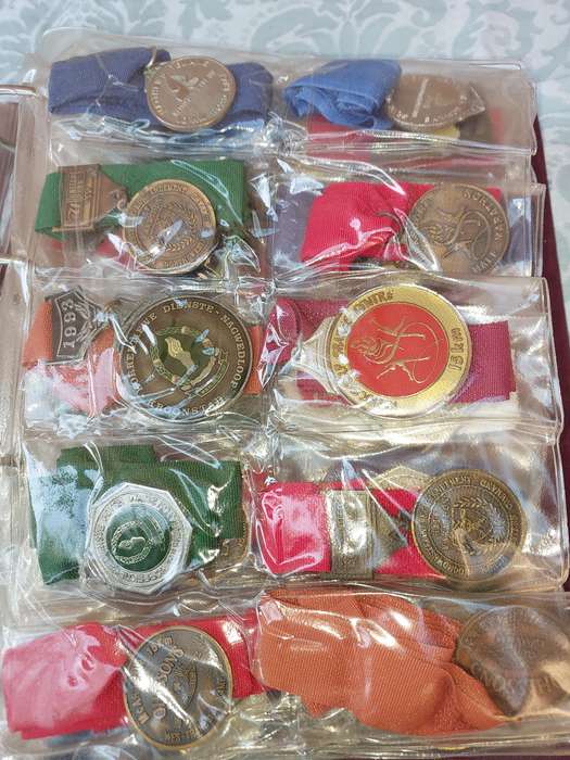 AN ENTIRE ATHLETES ALBUM WITH ALL THE MEDALS SOLD AS IS