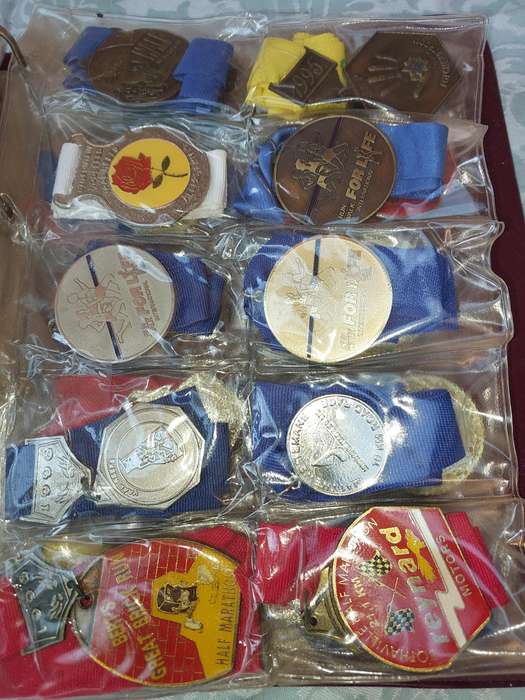 AN ENTIRE ATHLETES ALBUM WITH ALL THE MEDALS SOLD AS IS