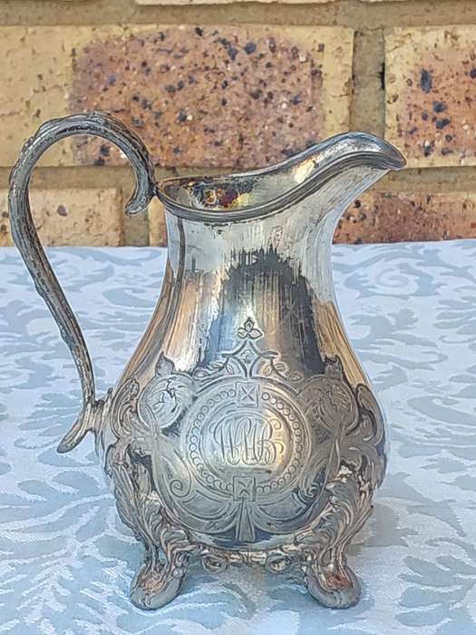 AN ANTIQUE DICKSON AND SONS SHEFFIELD ENGRAVED JUG SOLD AS IS