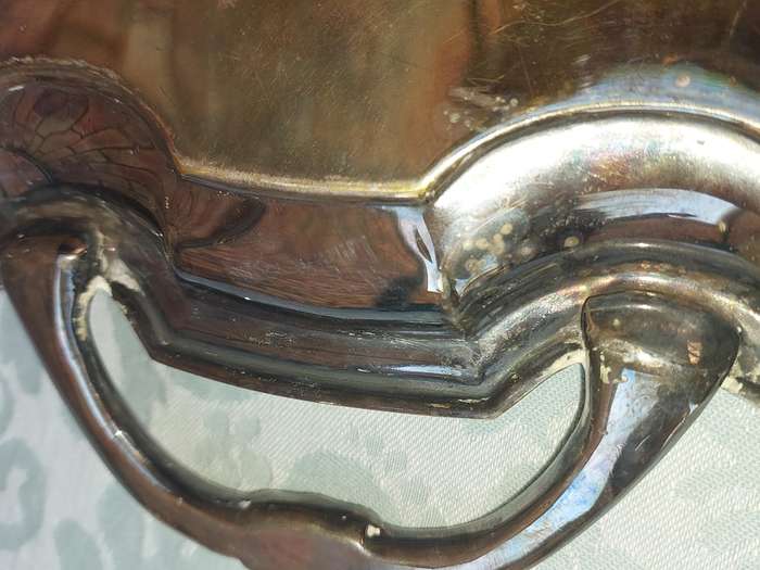 AN ANTIQUE 53 CENTIMETER SILVER PLATED ON BRONZE SERVING TRAY WIYH ENGRAVINGS SOLD AS IS