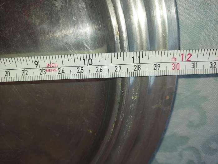 A ROUND PEWTAL SERVING TRAY  SOLD AS IS