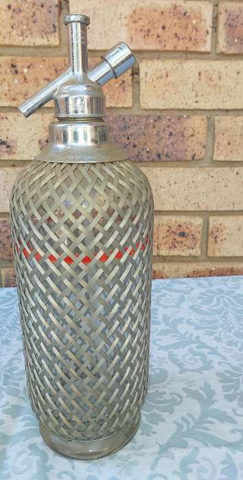 A VINTAGE SPARKLING WATER MAKER WITH WIRE MESH SOLD AS IS