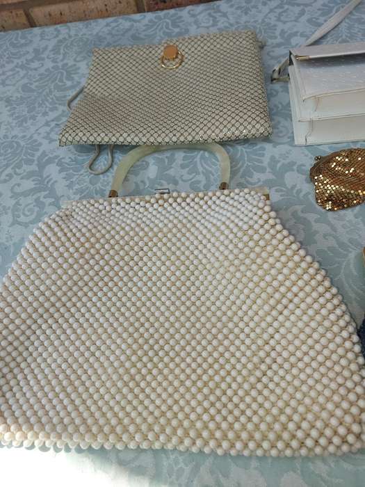 A COLLECTION OF HAND BAGS AND PURSES SOLD AS IS