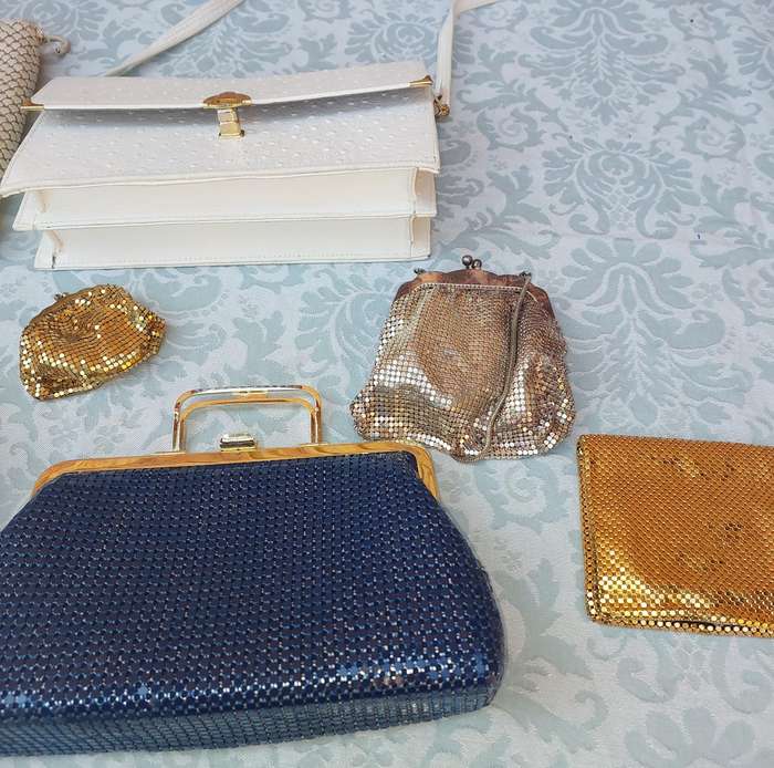 A COLLECTION OF HAND BAGS AND PURSES SOLD AS IS