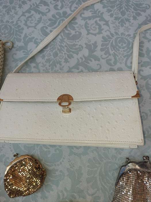 A COLLECTION OF HAND BAGS AND PURSES SOLD AS IS