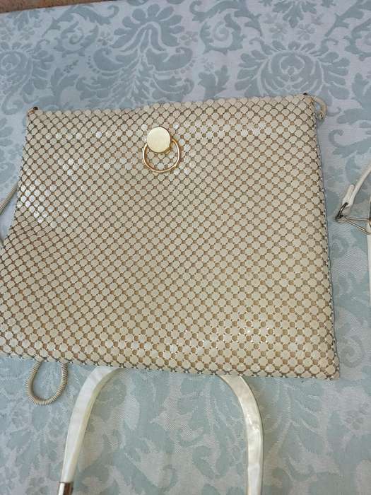 A COLLECTION OF HAND BAGS AND PURSES SOLD AS IS