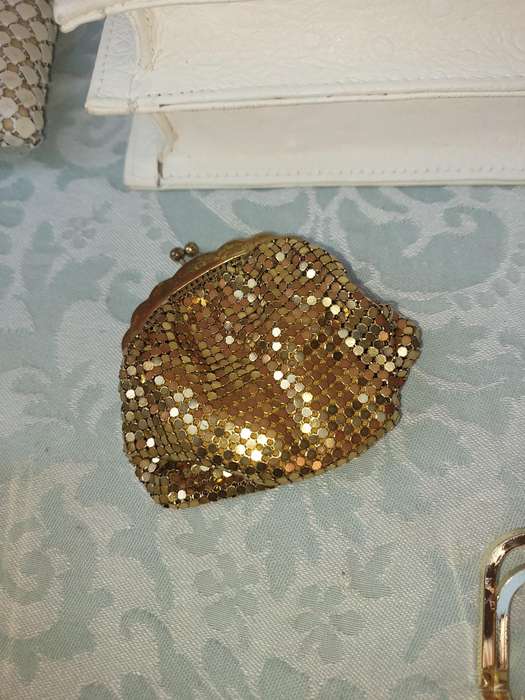 A COLLECTION OF HAND BAGS AND PURSES SOLD AS IS