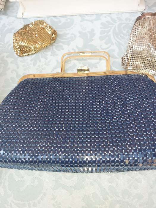 A COLLECTION OF HAND BAGS AND PURSES SOLD AS IS