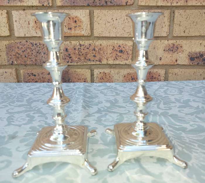 A PAIR OF ART DECOR CANDLE STANDS SOLD S IS