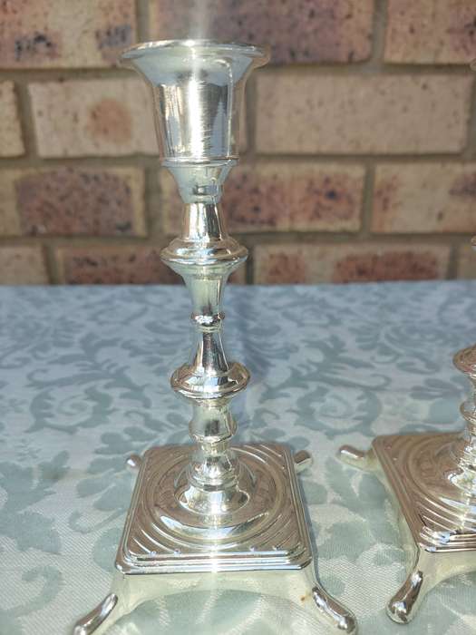 A PAIR OF ART DECOR CANDLE STANDS SOLD S IS