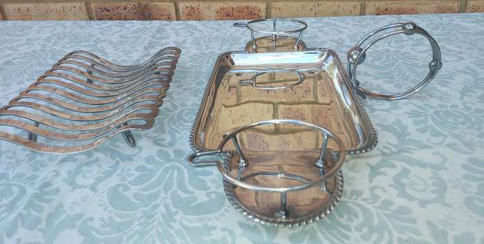 A VINTAGE ROAST TRAY WITH SAUCE HOLDERS AND A SCALLOPED HANDLE