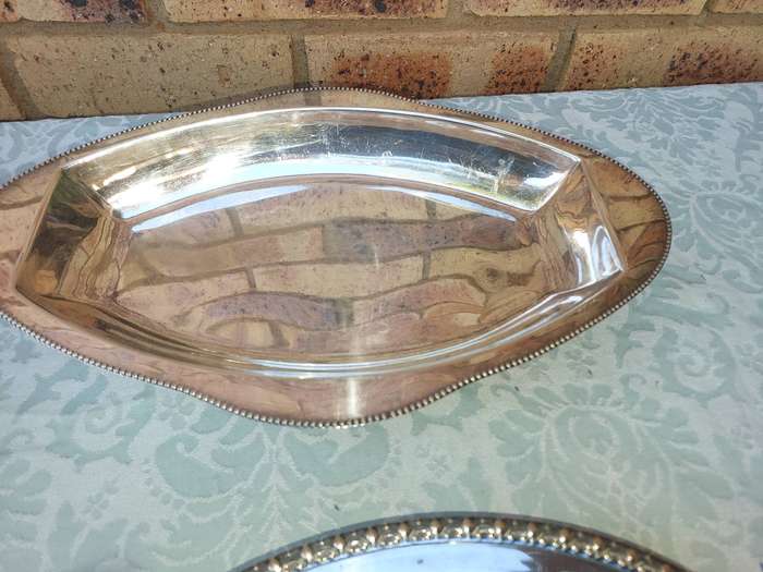 A COLLECTION OF SILVERPLATED AND STAINLESS STEEL WEDDING BASKET SERVING TRAYS