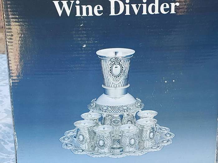 A VIRTUALLY NEW WINE DEVIDER OR KIDDUSH SET SOLD AS IS