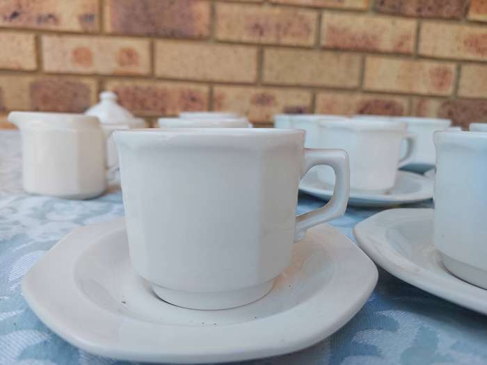 A COLLECTION OF EXPRESSO COFFEE CUPS AND SAUCERS