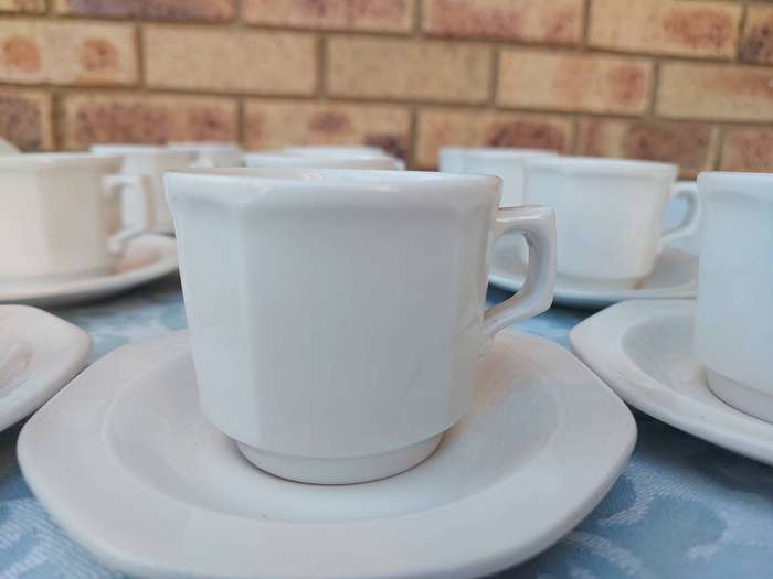 A COLLECTION OF EXPRESSO COFFEE CUPS AND SAUCERS